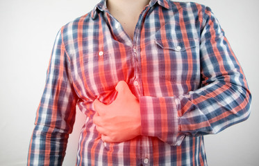 A man grabs his right side under the ribs. Pain in the liver. Pain syndrome in liver disease. - obrazy, fototapety, plakaty