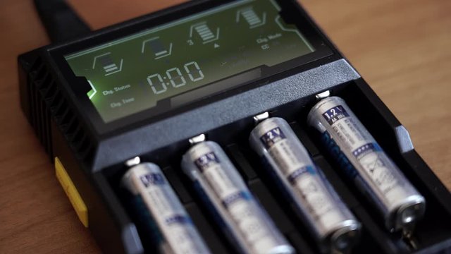 Batteries in the charger. Charge indicator.