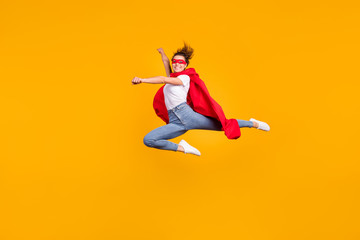 Fototapeta na wymiar Full length body size view of her she nice attractive lovely fit slim cheerful cheery girl jumping wearing cape rescuing planet isolated on bright vivid shine vibrant yellow color background