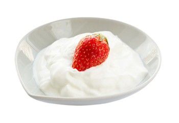 Morning breakfast with greek yogurt and and whole fresh strawberry on top isolated on white background. Side view.