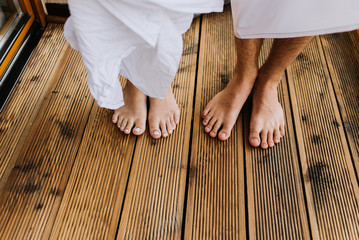 Legs of man and woman on the terrace