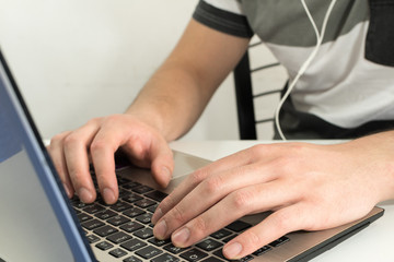 Fototapeta na wymiar Close up, Young man typing on his laptop