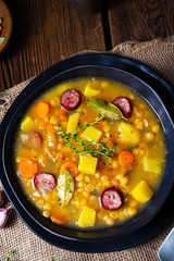 Rustic pea soup with bacon and sausages