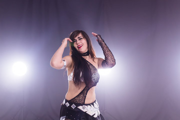 Portrait of a woman in oriental costume performing belly dance. Tribal fusion dance concept.