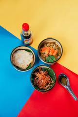 Fun colorful pinto box Thai noodles lunch set on vivid background