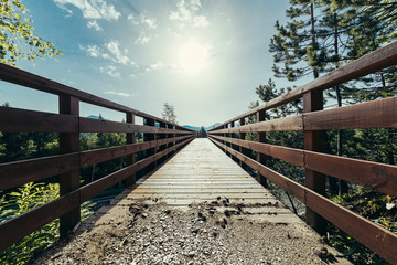 Frontal view of symmetrical view of wood bridge going away