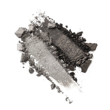 Close-up of make-up swatches. Smears of crushed shiny gray eye shadow