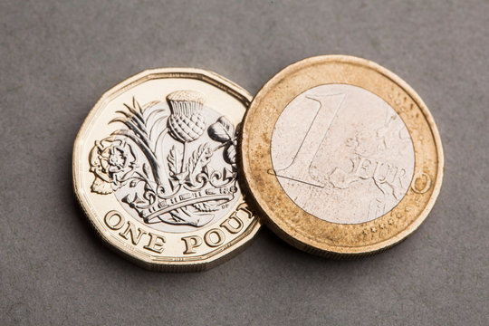 British one pound coin and one euro coin. Exchange rate concept