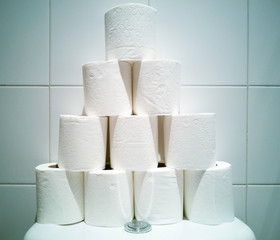 Many rolls of white toilet paper in tower