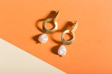 Top view of fashion jewelry and accessories on bright color background. Luxurious jewelry...