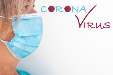 Close up of senior woman wearing blue protective mask against coronavirus contagion, white background. Side view of face