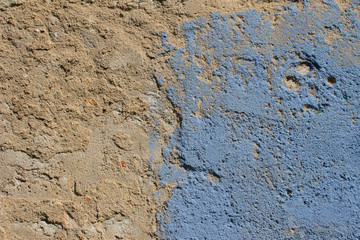 Old and weathered wall with light blue paint plaster fallen off on on one side for background