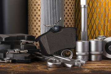 set of tools, pads and filters for car maintenance on a wooden table © kurgu128