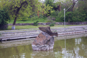 Statue of fish in lake