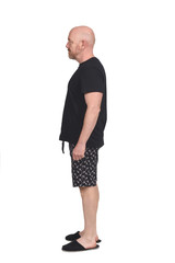 man in short pant pajamas on white background, side view