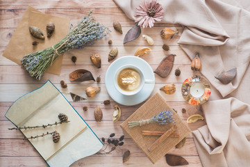 Coffee cup flat lay on wooden background. Cozy autumn composition with details of still life. Autumn mood.