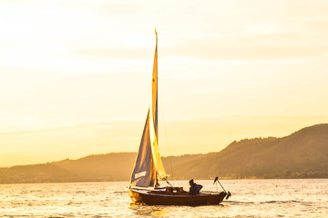 Sailboat with beautiful bright sun rays in Bodensee, DE 