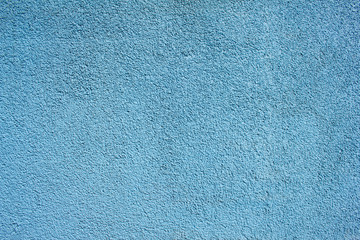 Fototapeta premium Blue painted wall with rough surface texture background.
