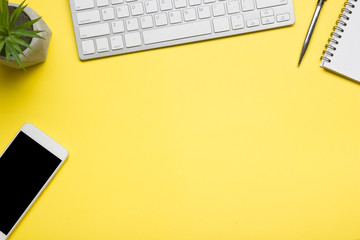 White desk office with laptop, smartphone and other work supplies with cup of coffee. Top view with copy space for input the text. Designer workspace on desk table essential elements on flat lay