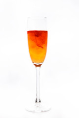 colored water in a glass on a white background. bright colors contrast