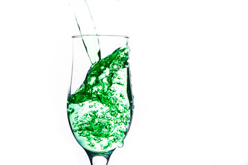 colored water in a glass on a white background. bright colors contrast