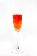 colored water in a glass on a white background. bright colors contrast