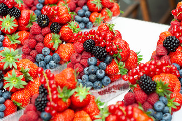 Sale juicy, fresh strawberries, raspberries and blackberries in market square, Prague, Czech Republic.