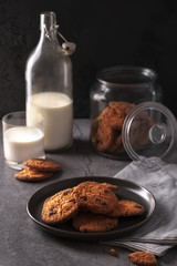Homemade freshly baked cookies with chocolate pieces with a bottle of milk