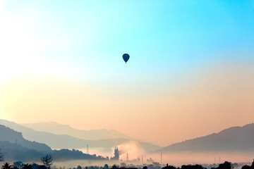 Soft focus misty mountain forest and hot air balloon  landscape in morning time