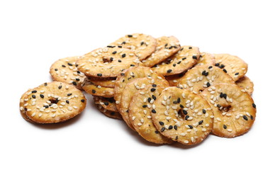 Baked pretzels with black and white sesame seeds, savory snacks isolated on white background