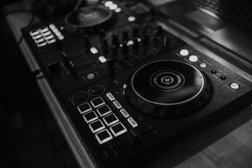 Dj deck controls in black and white. Blurred background