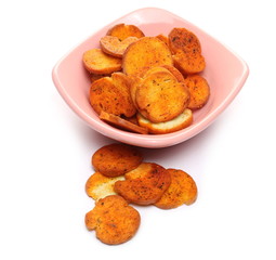 Bruschette chips, grilled bread crisps with tomatoes, olives and oregano, savory snacks in porcelain bowl isolated on white background