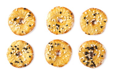 Baked pretzels with black and white sesame seeds, savory snacks set and collection isolated on white background, top view