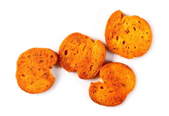 Bruschette chips, grilled bread crisps with tomatoes, olives and oregano, savory snacks isolated on white background, top view