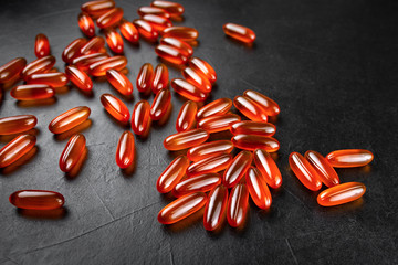 orange pills on a black background