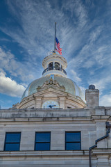Fototapeta na wymiar Dome clock and flag on Old Savannah City Hall