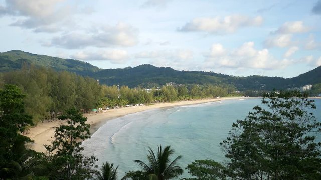 Panoramic of  Kamala beach, sea wave water hit sand shore ,pine tree along the coast, mountain long distance, white cloud on blue sky background at day time