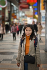 Obraz na płótnie Canvas Traveller female posting on shopping street market in Osaka Japan.