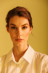 Image of serious successful woman posing and looking at camera
