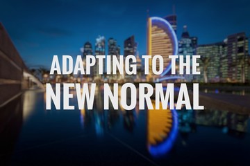 ADAPTING TO THE NEW NORMAL text on blurred background of Doha City. New normal after Covid-19...