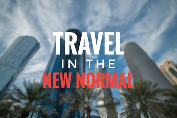 TRAVEL IN THE NEW NORMAL text on blurred background of Doha City. New normal after Covid-19...