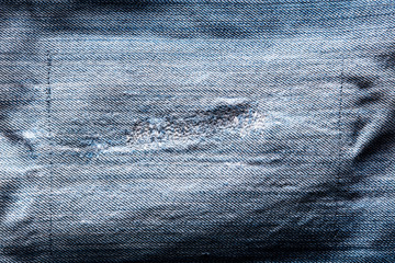 Blue jeans denim texture with a patch
