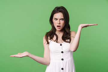 Image of displeased beautiful woman posing and holding copyspace