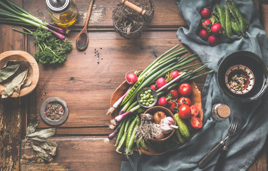 Healthy vegetarian eating and home cooking concept. Vegan ingredients on rustic wooden table with...