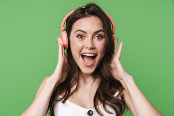 Image of cheerful nice woman singing while using wireless headphones