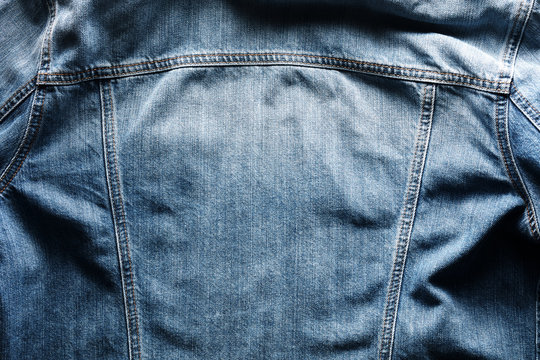 Back side of a vintage blue jeans or denim jacket with copy space
