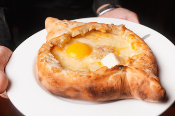 Georgian khachapuri with butter and raw egg