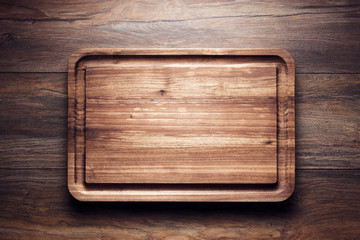 Empty vintage wooden cutting board on wooden table
