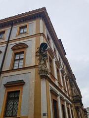 Sculpture on the facade of a historic building in the center of Prague