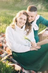 A guy and a girl love each other, smile, hug, kiss, laugh, enjoy life in the forest on a cliff, in...